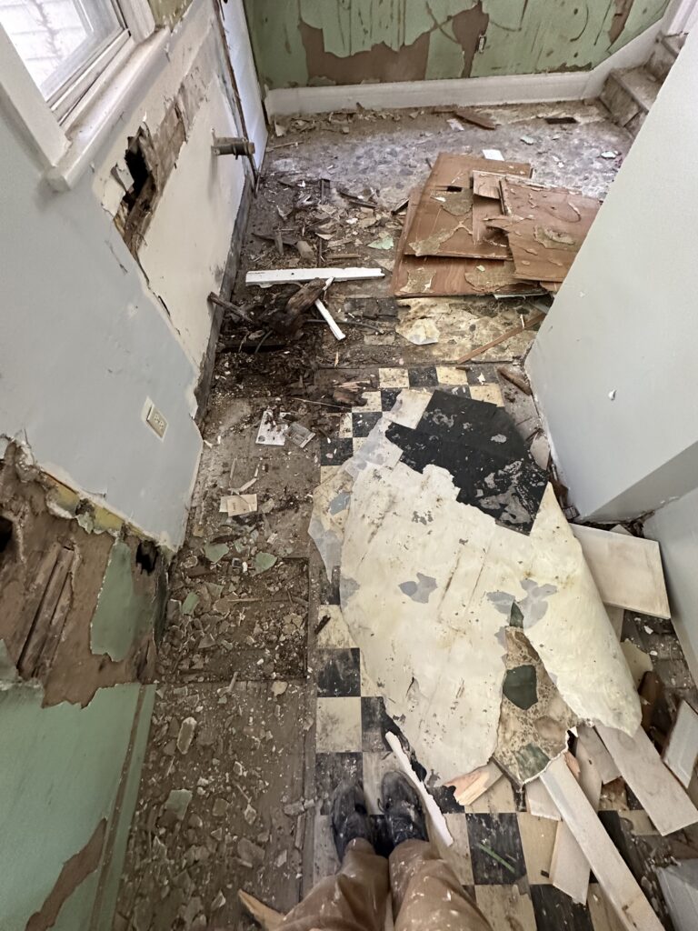 Old tile and flooring layers removed from the kitchen